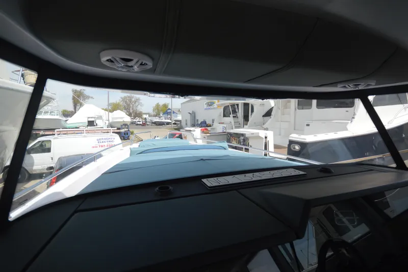 Slide: The Image of Interior view from the 2024 Axopar 37 XC Cross Cabin, showcasing marina surroundings. - 42