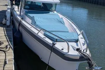 Slide: The Image of 2024 Axopar 37 XC Cross Cabin boat docked at marina. - 44