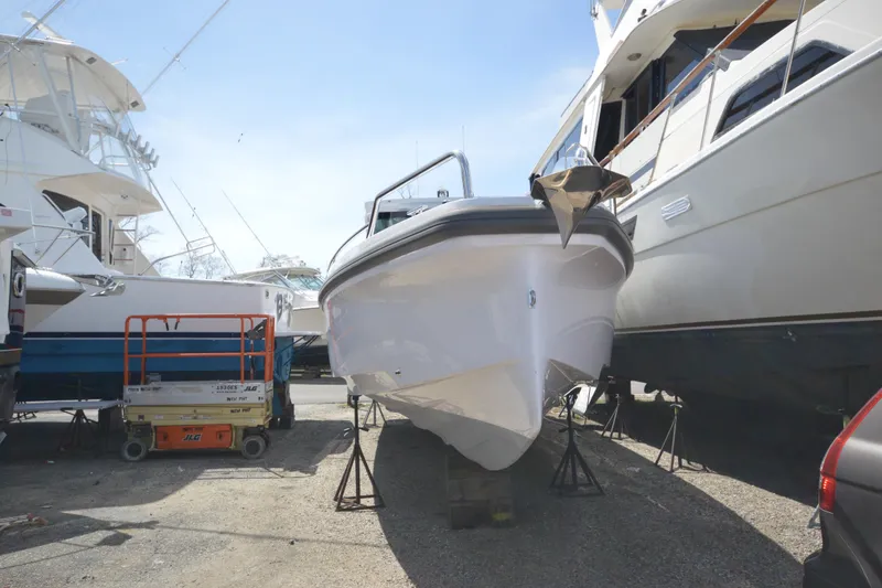 Slide: The Image of 2024 Axopar 37 XC Cross Cabin boat on stands in a marina. - 5