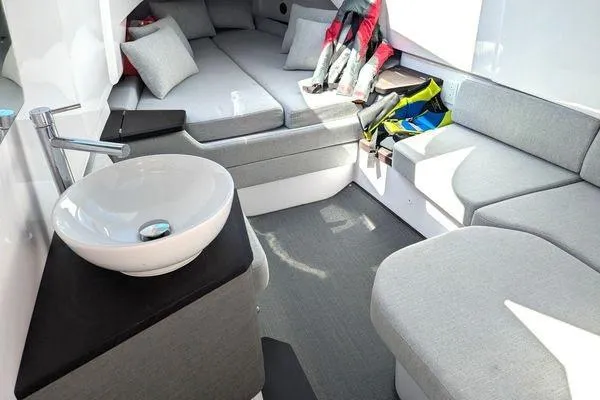 Slide: The Image of 2024 Axopar 37 XC Cross Cabin interior with modern seating and compact sink. - 50