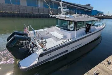Slide: The Image of 2024 Axopar 37 XC Cross Cabin boat docked in a marina, featuring sleek design and powerful engines. - 51