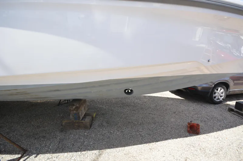 Slide: The Image of 2024 Axopar 37 XC Cross Cabin hull on dry dock, showcasing sleek design. - 7