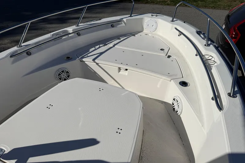 Slide: The Image of 2023 Boston Whaler 220 Dauntless boat interior with seating and stainless steel railings. - 4