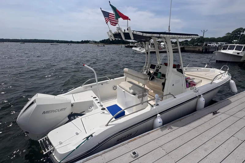 Slide: The Image of 2023 Boston Whaler 220 Dauntless boat console with steering wheel and controls. - 9