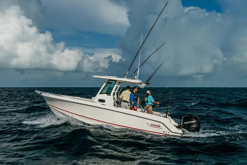 Slide: The Image of Manufacturer Provided Image: 2025 Boston Whaler 250 Outrage boat navigating ocean waves under cloudy sky. - 2