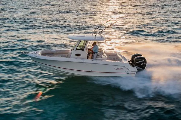 Slide: The Image of Manufacturer Provided Image: 2025 Boston Whaler 250 Outrage cruising on open water at sunset. - 6