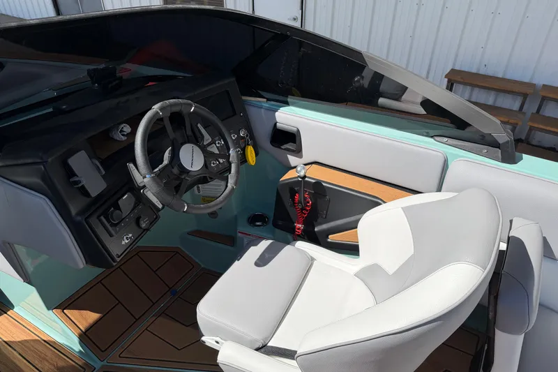 Slide: The Image of 2025 Moomba Mojo boat interior with modern steering wheel and sleek dashboard design. - 11