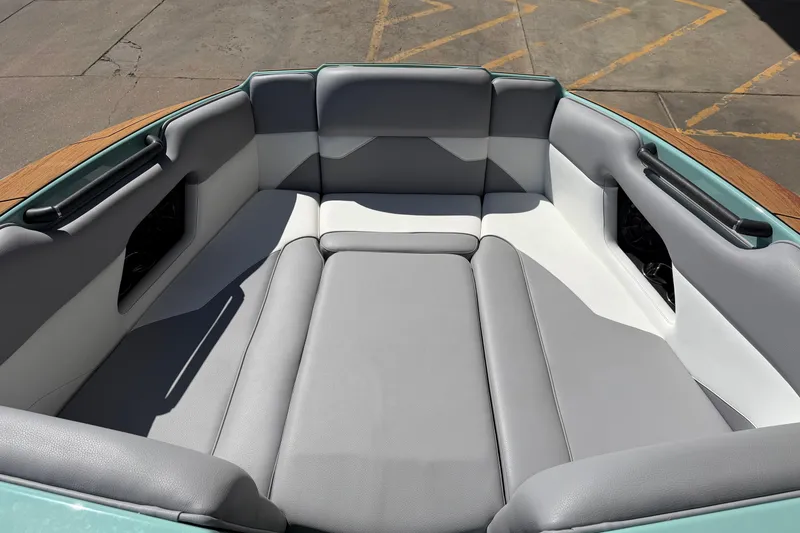 Slide: The Image of 2025 Moomba Mojo boat interior with gray and white cushioned seating. - 12