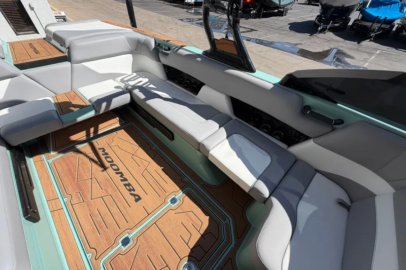 Slide: The Image of 2025 Moomba Mojo boat interior with sleek seating and stylish flooring design. - 13