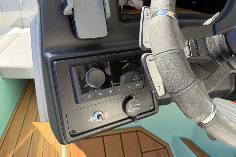 Slide: The Image of 2025 Moomba Mojo dashboard with audio controls and steering wheel detail. - 15