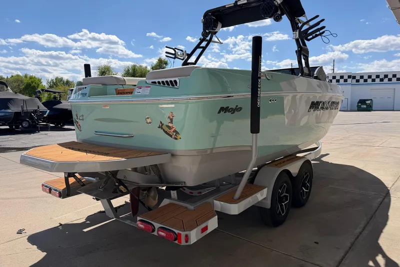 Slide: The Image of 2025 Moomba Mojo boat on trailer, featuring sleek design and vibrant color under a sunny sky. - 5