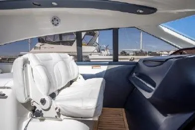 Slide: The Image of Interior of 2003 Viking Princess 65 yacht with white seating and wooden flooring. - 15