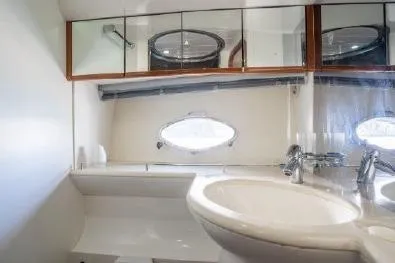 Slide: The Image of Bathroom interior of 2003 Viking Princess 65 yacht with modern fixtures and oval window. - 20