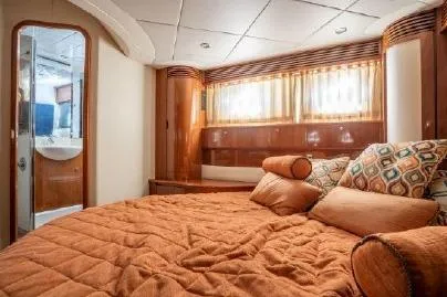 Slide: The Image of Luxurious bedroom interior of 2003 Viking Princess 65 yacht with elegant wood finishes. - 22