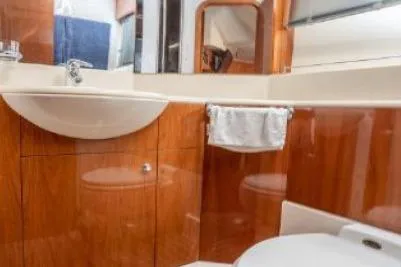 Slide: The Image of Luxurious bathroom interior of 2003 Viking Princess 65 yacht with wooden cabinetry. - 23
