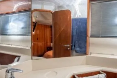 Slide: The Image of Interior of 2003 Viking Princess 65 yacht, featuring a modern bathroom with wood accents. - 24