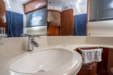 Slide: The Image of Bathroom interior of 2003 Viking Princess 65 yacht with modern sink and mirror. - 25