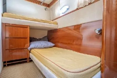 Slide: The Image of 2003 Viking Princess 65 yacht cabin with wooden interior and twin beds. - 29