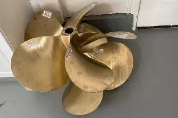 Slide: The Image of Bronze boat propeller for 2003 Viking Princess 65 yacht, displayed indoors. - 31