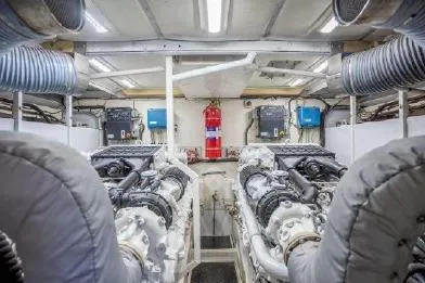 Slide: The Image of Engine room of 2003 Viking Princess 65 yacht, featuring dual engines and safety equipment. - 32