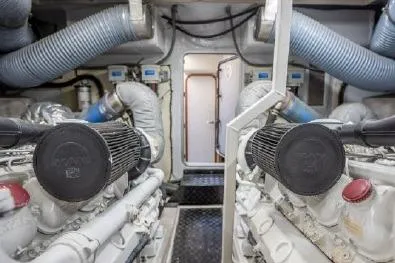 Slide: The Image of Engine room of 2003 Viking Princess 65 yacht, featuring dual engines and ventilation systems. - 33