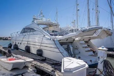 Slide: The Image of Luxury 2003 Viking Princess 65 yacht docked at marina under clear blue sky. - 5