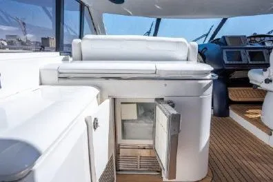 Slide: The Image of 2003 Viking Princess 65 yacht interior with open mini fridge and modern helm. - 7