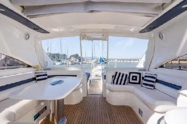 Slide: The Image of Luxurious 2003 Viking Princess 65 yacht interior with elegant seating and marina view. - 8