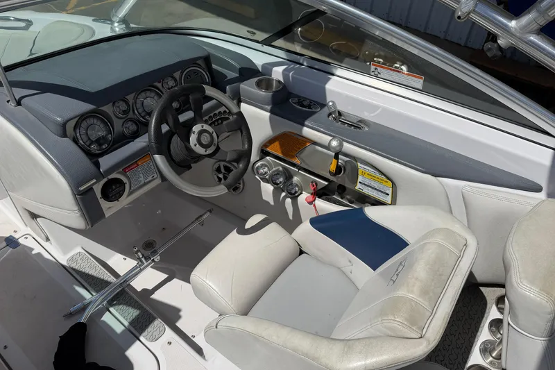 Slide: The Image of 2007 Nautique Crossover 236 boat cockpit with steering wheel and control panel. - 11