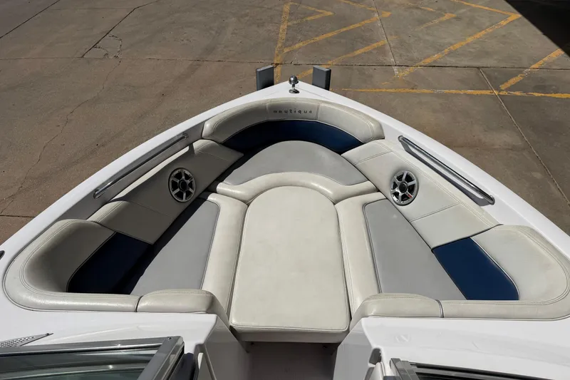 Slide: The Image of 2007 Nautique Crossover 236 boat interior with cushioned seating and built-in speakers. - 12