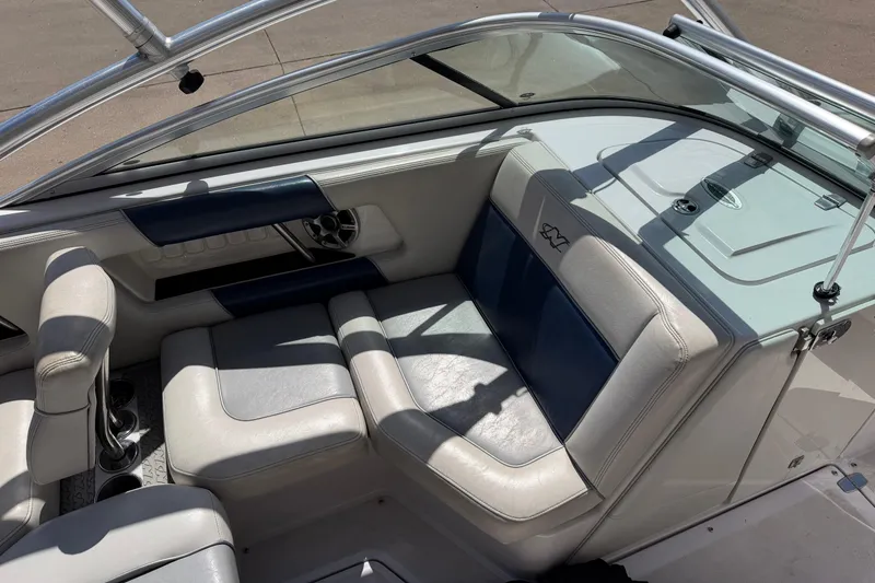 Slide: The Image of 2007 Nautique Crossover 236 boat interior with white and blue seating. - 13