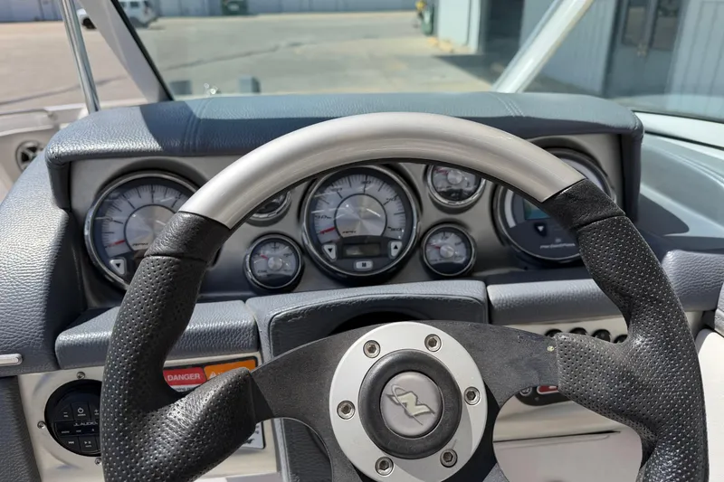 Slide: The Image of Steering wheel and dashboard of 2007 Nautique Crossover 236 boat. - 14