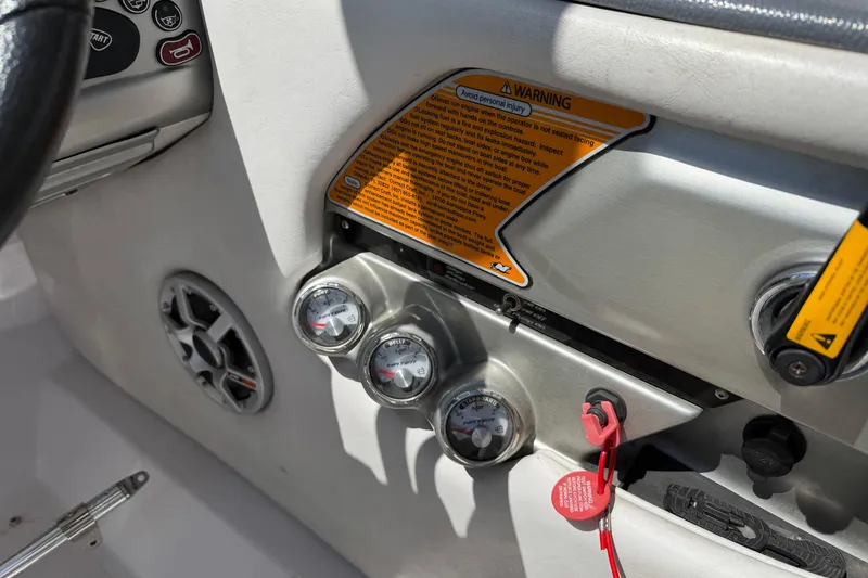 Slide: The Image of 2007 Nautique Crossover 236 dashboard with gauges, warning labels, and control panel. - 15