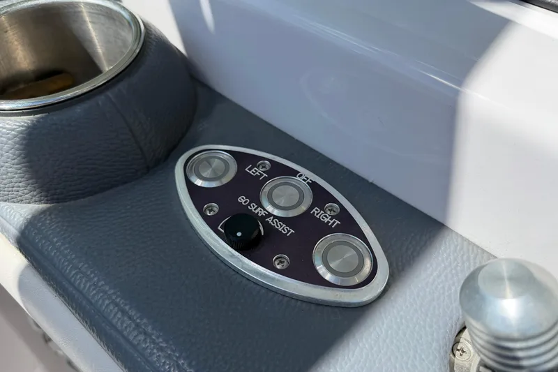 Slide: The Image of Control panel of 2007 Nautique Crossover 236 boat with surf assist buttons. - 16
