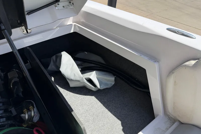 Slide: The Image of Storage compartment of a 2007 Nautique Crossover 236 boat, showing interior details. - 18