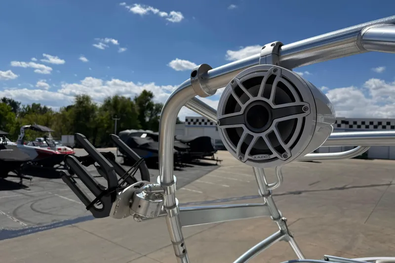 Slide: The Image of 2007 Nautique Crossover 236 boat with JL Audio speaker and wakeboard rack under clear sky. - 20