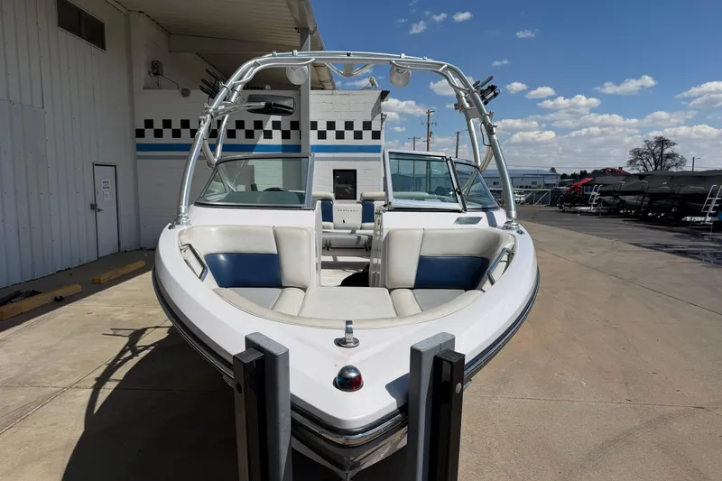 Slide: The Image of 2007 Nautique Crossover 236 boat with tower, parked outdoors under a clear sky. - 8
