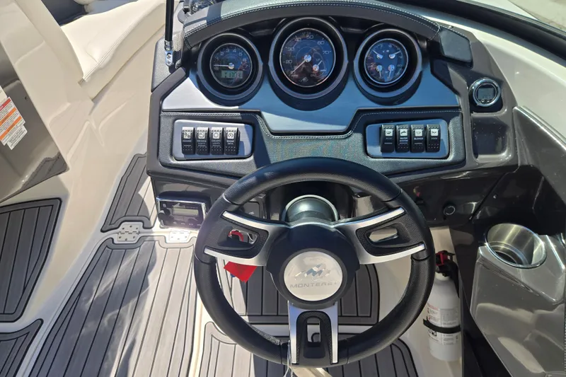 Slide: The Image of Dashboard of a 2014 Monterey 214SS Super Sport boat with steering wheel and gauges. - 12