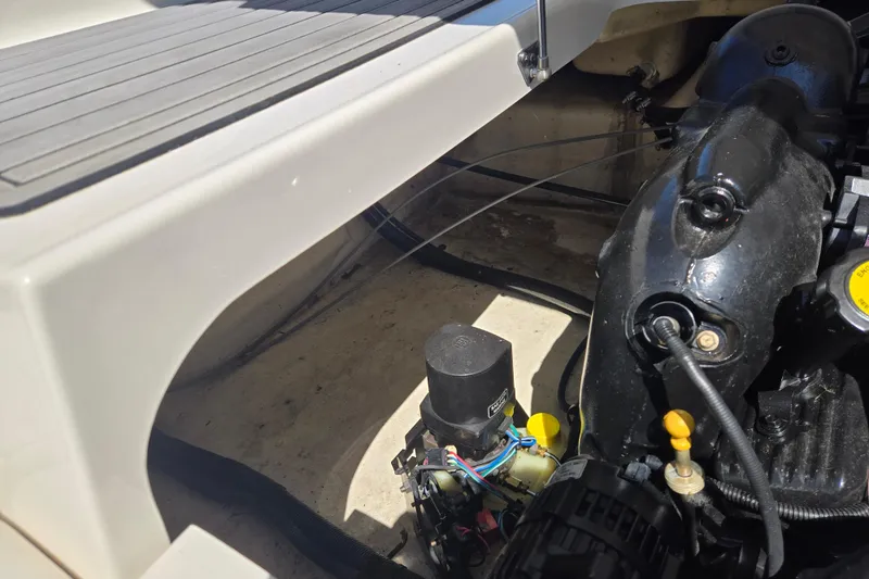 Slide: The Image of Engine compartment of a 2014 Monterey 214SS Super Sport boat, showcasing mechanical components. - 14