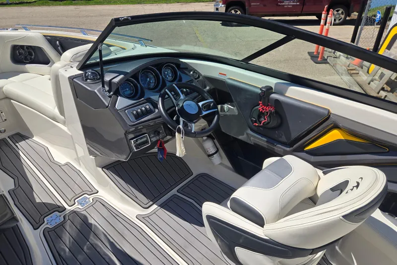 Slide: The Image of 2014 Monterey 214SS Super Sport boat interior with sleek dashboard and comfortable seating. - 21