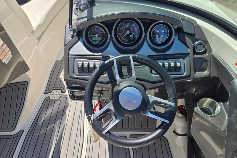 Slide: The Image of Steering wheel and dashboard of a 2014 Monterey 214SS Super Sport boat. - 23