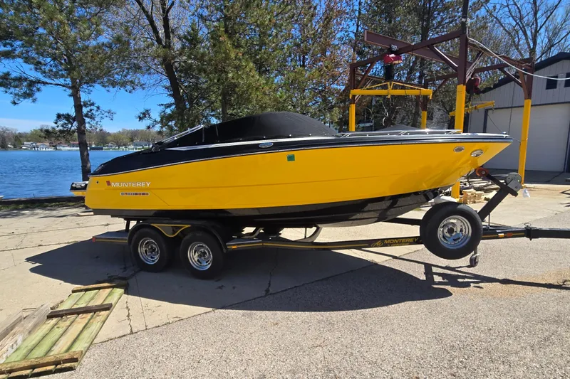 Slide: The Image of Yellow 2014 Monterey 214SS Super Sport boat on trailer by a lake. - 3