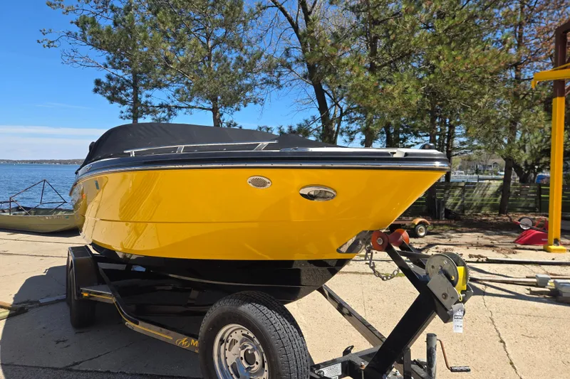 Slide: The Image of Yellow 2014 Monterey 214SS Super Sport boat on trailer by lakeside with trees in background. - 4