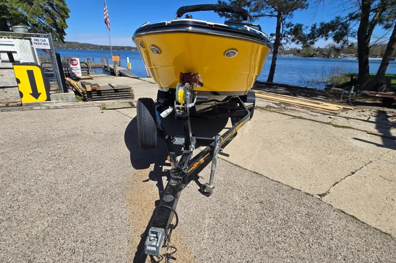 Slide: The Image of Yellow 2014 Monterey 214SS Super Sport boat on trailer by a lake. - 5