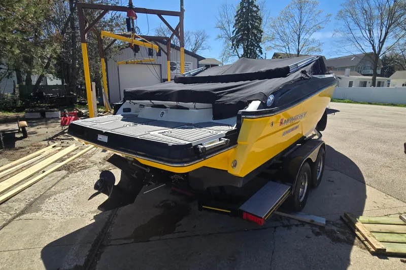 Slide: The Image of 2014 Monterey 214SS Super Sport boat, yellow with black cover, on trailer in driveway. - 6