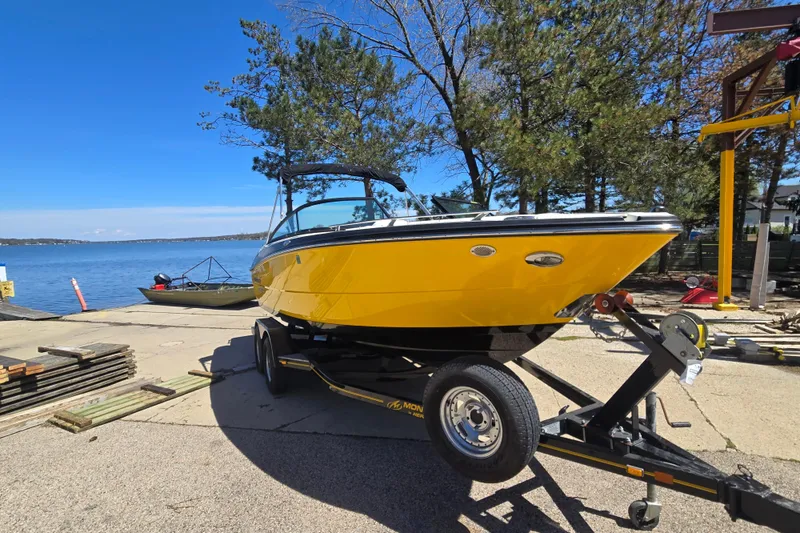 Slide: The Image of 2014 Monterey 214SS Super Sport boat on trailer by a lakeside dock. - 7