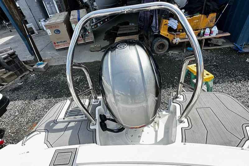 Slide: The Image of 2022 Godfrey Hurricane 185 SD boat engine with stainless steel railings in a workshop setting. - 11