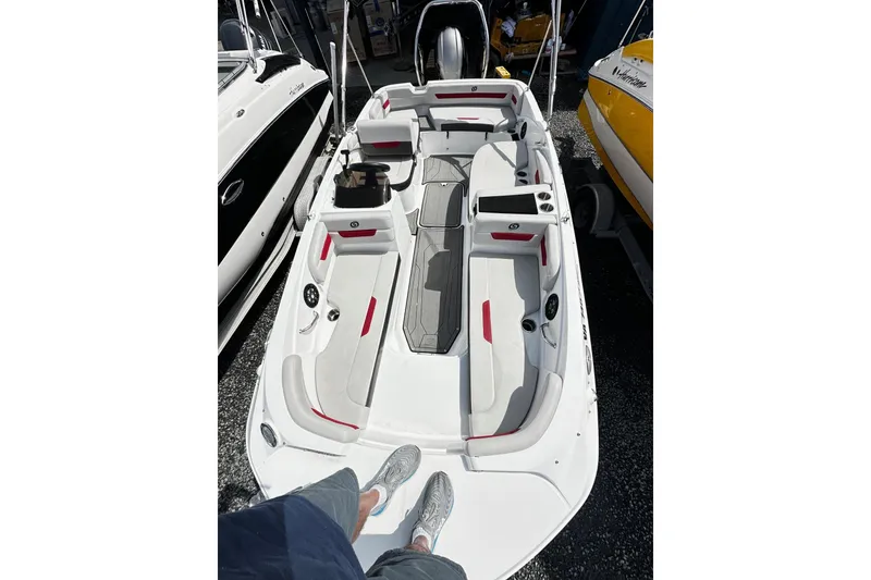 Slide: The Image of 2022 Godfrey Hurricane 185 SD boat interior with white and red seating, docked. - 5