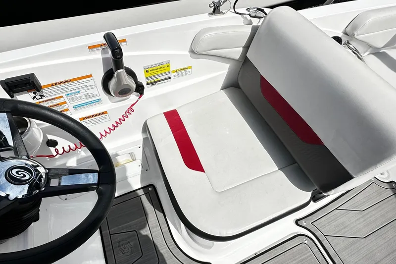 Slide: The Image of Steering area of 2022 Godfrey Hurricane 185 SD boat with red-accented seat. - 7