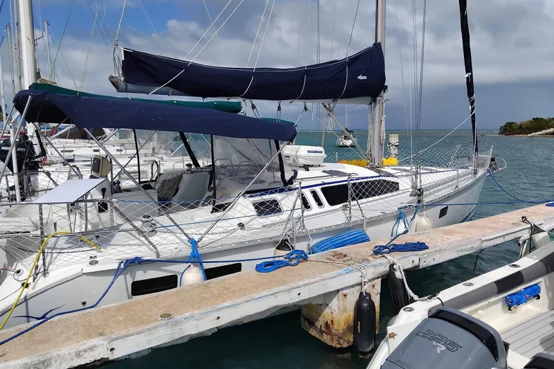 The Image of Sailboat docked at marina, 1994 Hunter Legend 40.5, with blue covers and netting. - 0